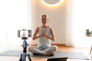 Yoga teacher, 40+ gives online yoga classes. Online video yoga class using a smartphone. Yoga teacher, 40+ gives online yoga classes. Online video yoga class using a smartphone.